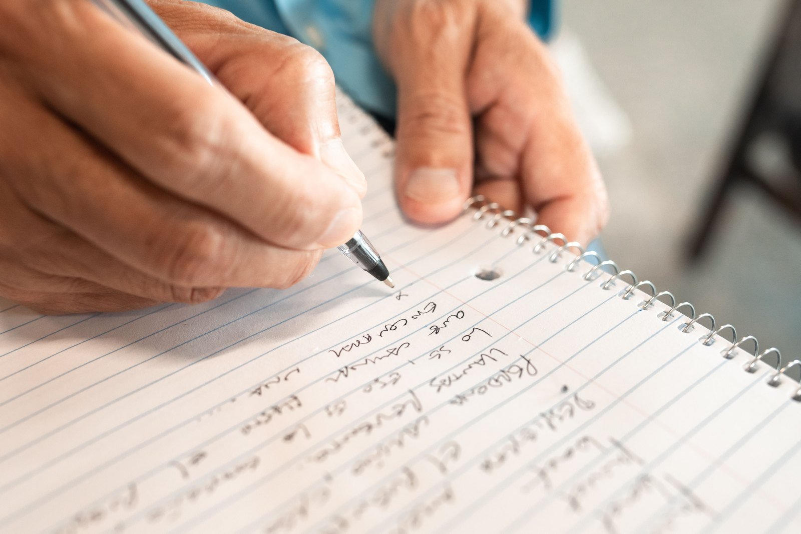 A notebook and a phone on a kitchen table at night, where the seizure notes get written.