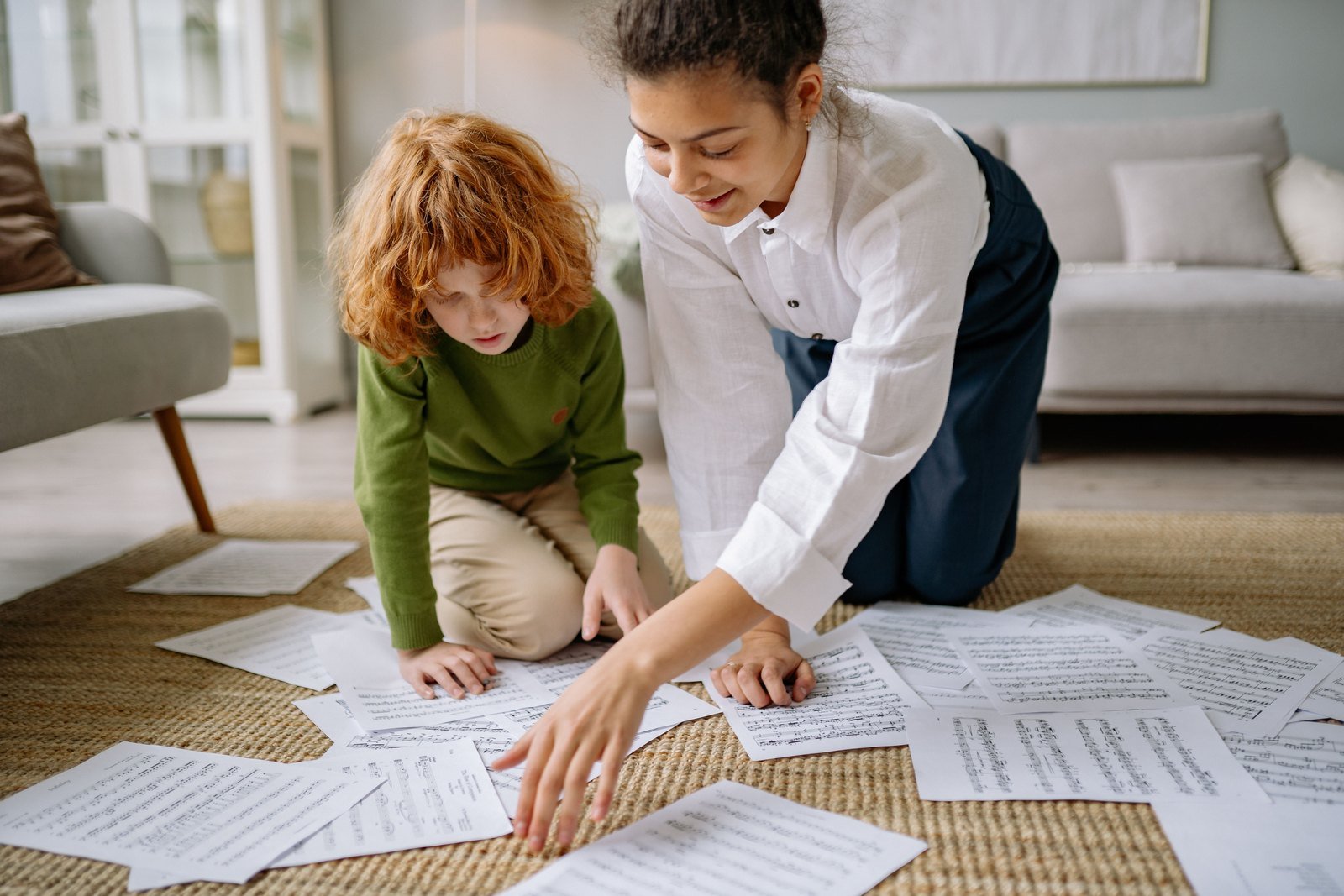 A stack of papers sorted into piles on a living room floor, ready to be filed or scanned